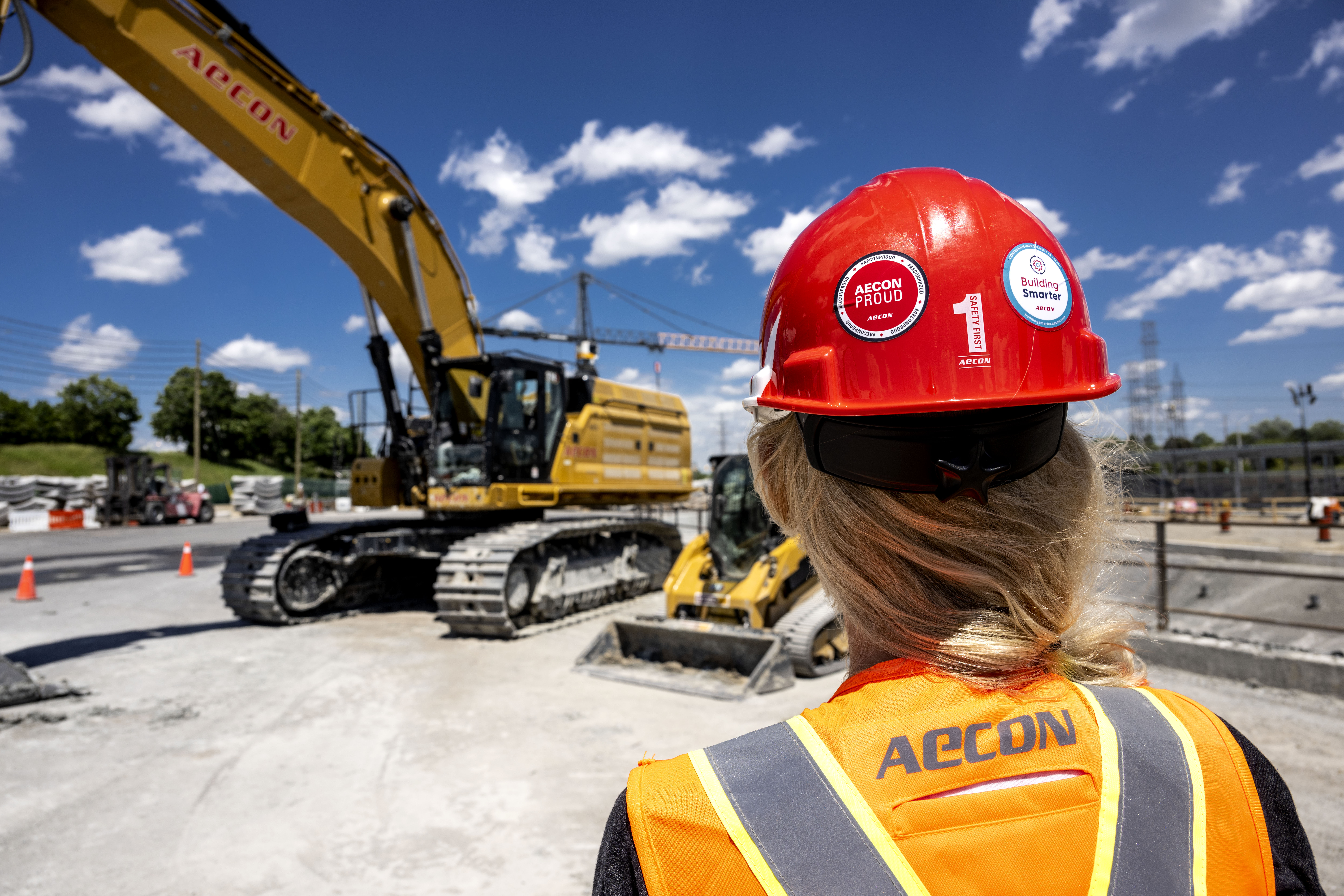Woman wearing a hard hat on a construction site.